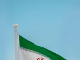 iran national flag under blue sky