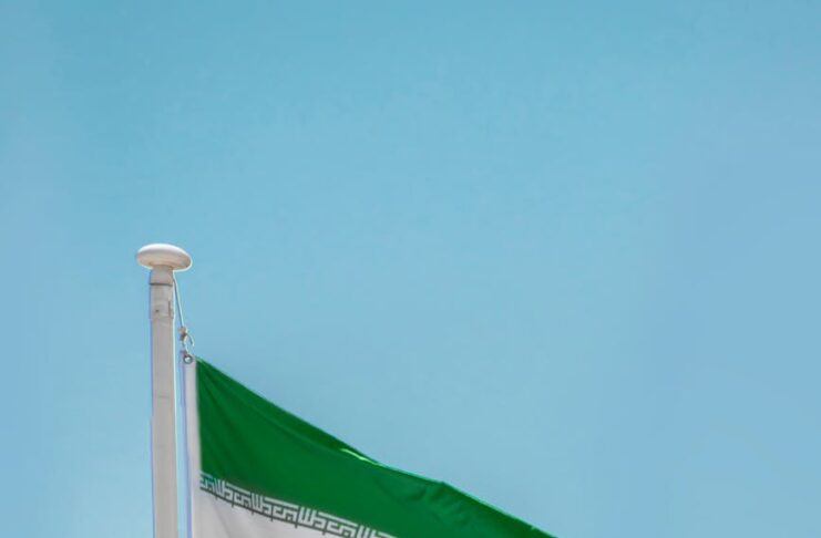 iran national flag under blue sky